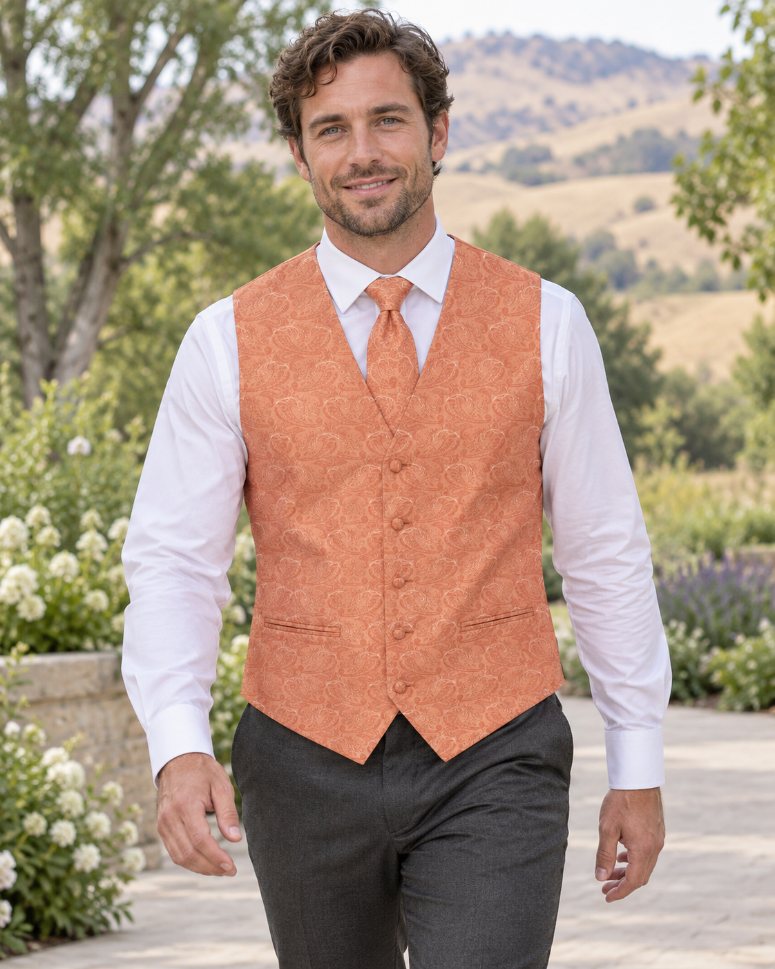 Paisley Orange men's vest set on model at outdoor Boise-area wedding setting