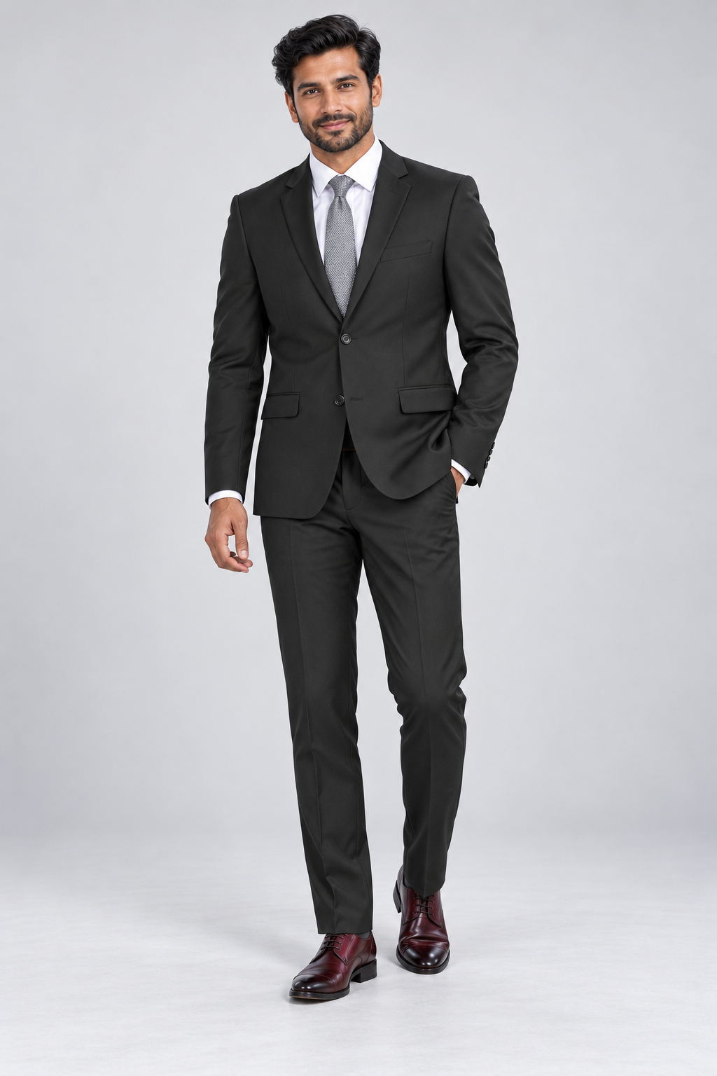 Renoir Men’s Slim Fit Black 2 Piece Suit — model photograph in a minimalist photographic studio with seamless pale gray backdrop and floor, large softbox lighting