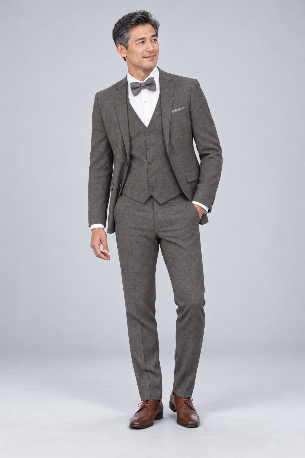 "The Brunswick" Men's Slim Fit Cafe 3 Piece Suit — model photograph in a minimalist photographic studio with seamless pale gray backdrop and floor, large softbox lighting