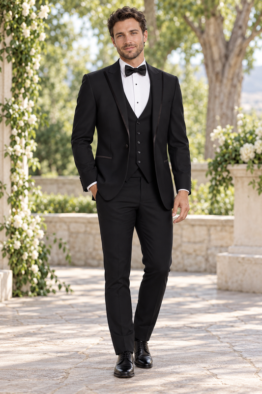"The Colin" Men's Slim Fit Black 3 Piece 1 Button Peak Tuxedo shown in professional outdoor wedding photography