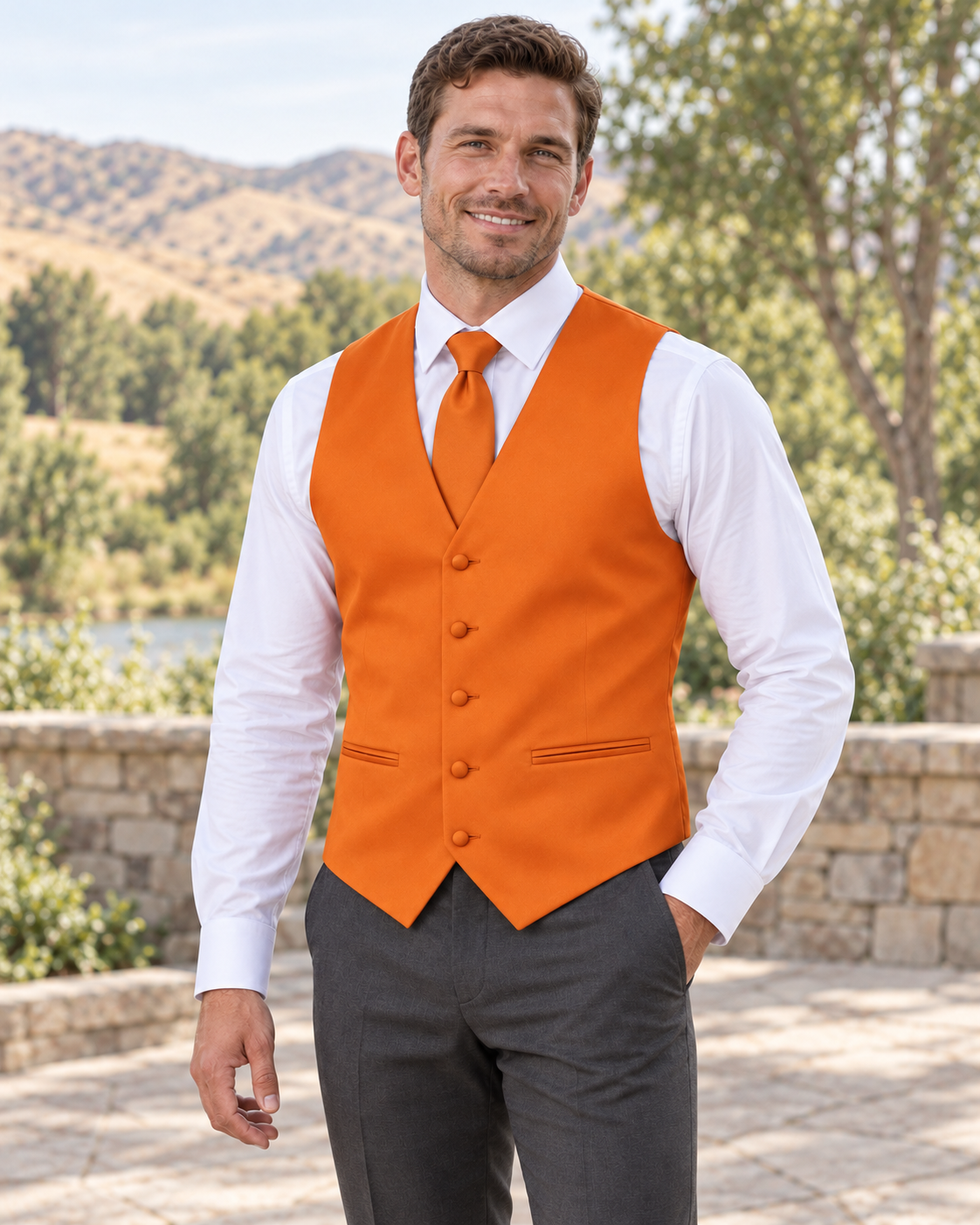 Orange satin vest with coordinating necktie on a model in an outdoor Idaho wedding setting