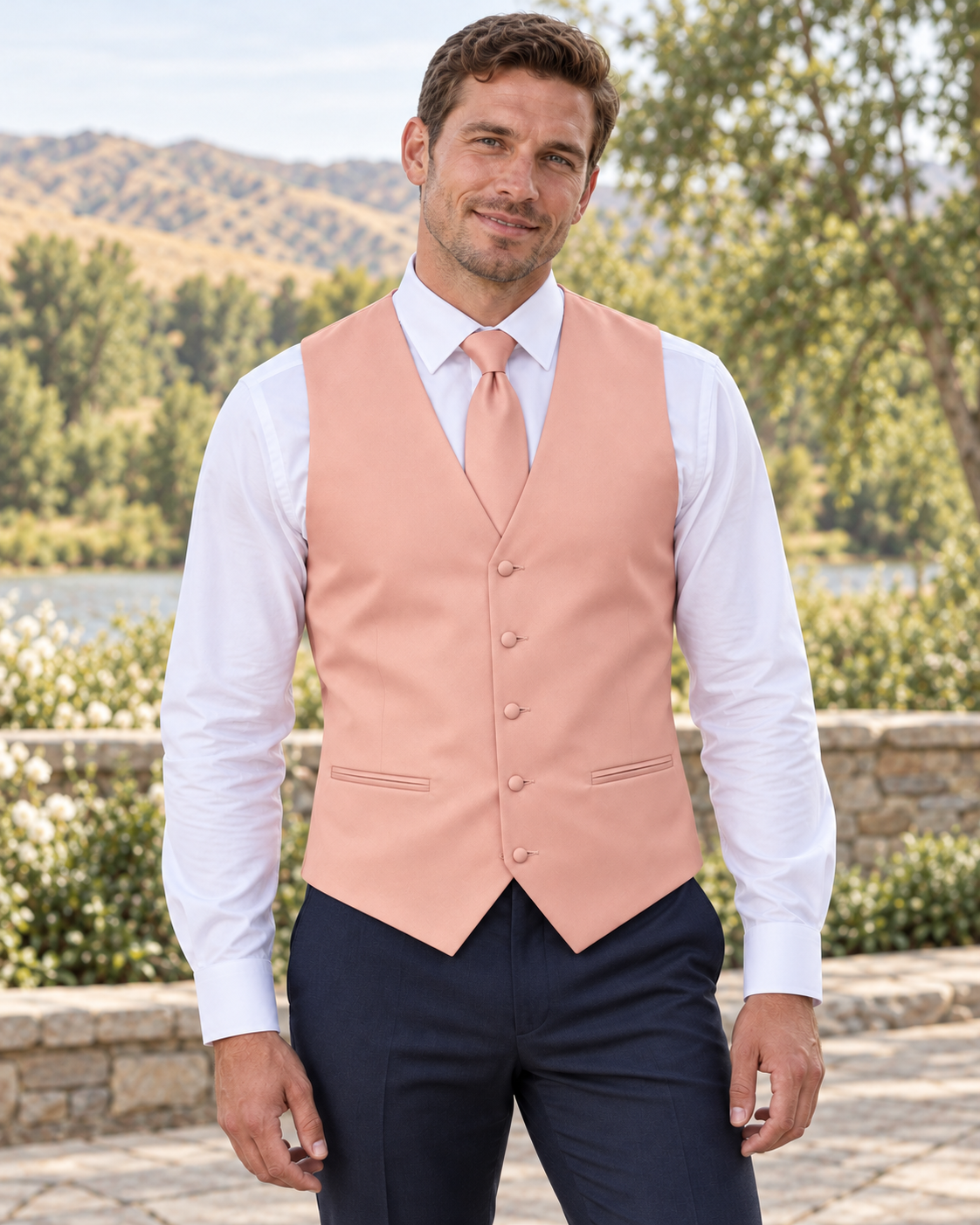 Petal Peach satin vest with coordinating necktie on a model in an outdoor Idaho wedding setting